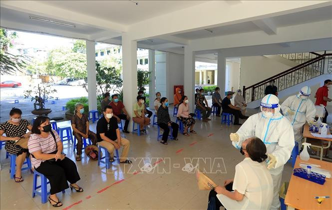 Lấy mẫu xét nghiệm cho người dân sàng lọc SARS-CoV-2. Ảnh: TTXVN