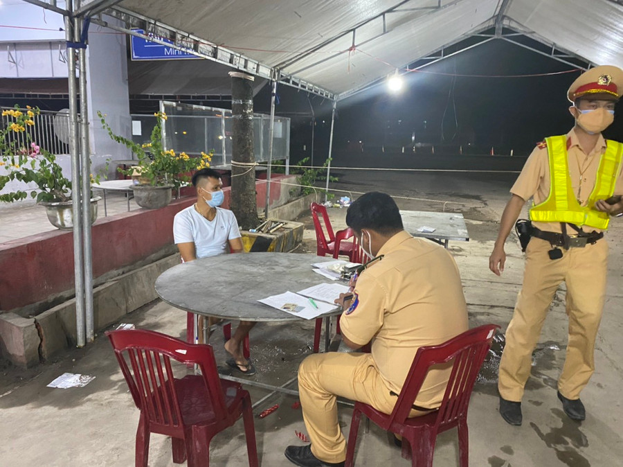 CSGT Bình Thuận làm việc với tài xế xe đông lạnh tại chốt kiểm dịch. Ảnh: KHÔI NGUYỄN CSGT Bình Thuận làm việc với tài xế xe đông lạnh tại chốt kiểm dịch. Ảnh: KHÔI NGUYỄN