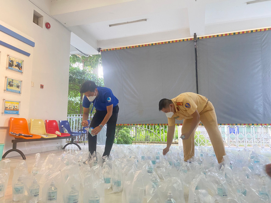 Lãnh đạo Quận đoàn 10 cùng anh Tuấn Anh phân phối thuốc. Ảnh: Tấn Đạt 