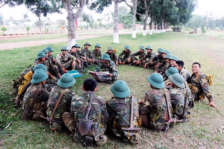 Trong thời gian nghỉ giải lao, các chiến sĩ đọc báo cho nhau nghe