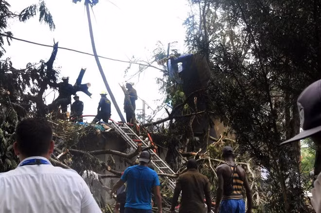 Lực lượng cứu hộ tìm kiếm các nạn nhân tại hiện trường máy bay rơi. (Nguồn: THX/TTXVN)