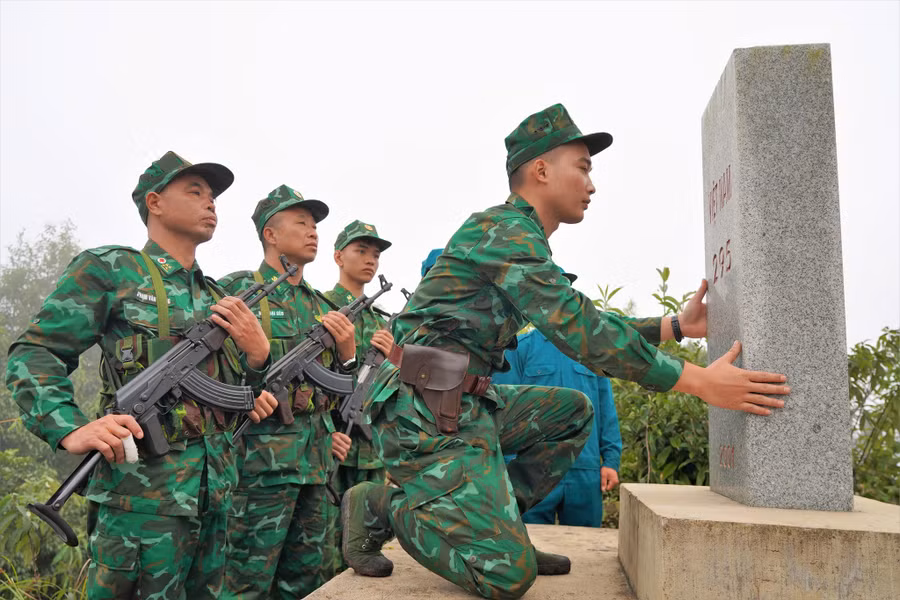 Thiếu úy Nông Tuấn Anh kiểm tra mốc giới 295. Ảnh: M.T.H - N.Đ.L