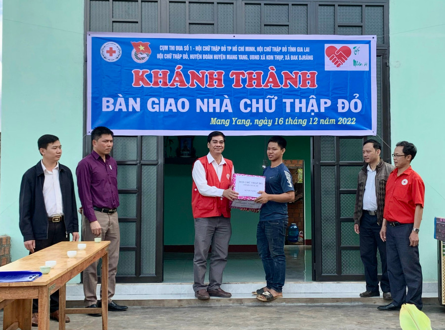 Đại diện Hội Chữ thập đỏ tỉnh Gia Lai và đại diện các ban, ngành, đoàn thể địa phương bàn giao nhà và tặng quà cho em Nguyễn Trung Hiếu- làng Groi, xã Kon Thụp, huyện Mang Yang. Ảnh: Như Nguyện