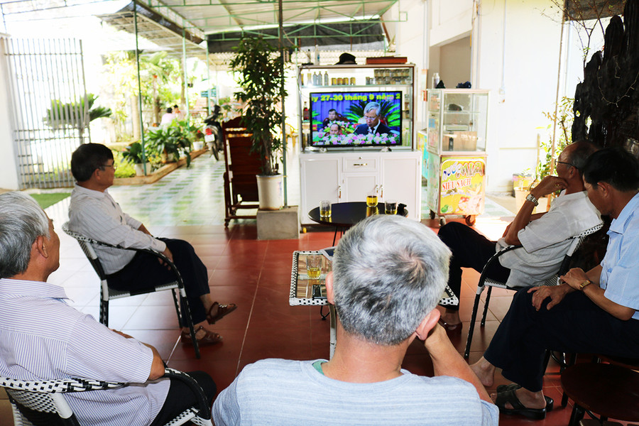 Người dân tổ 4, phường Thắng Lợi, thành phố Pleiku theo dõi diễn biến của Đại hội Đảng bộ tỉnh qua sóng truyền hình. Ảnh: Ngọc Sang