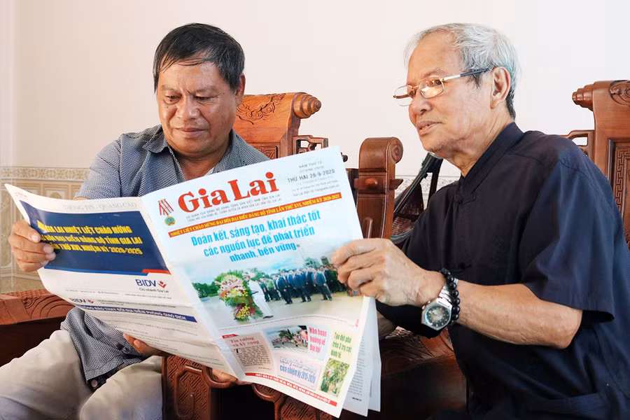 Người dân tổ 6, phường Trà Bá, thành phố Pleiku đọc báo nắm thông tin về Đại hội Đảng bộ tỉnh lần thứ XVI. Ảnh: Ngọc Sang