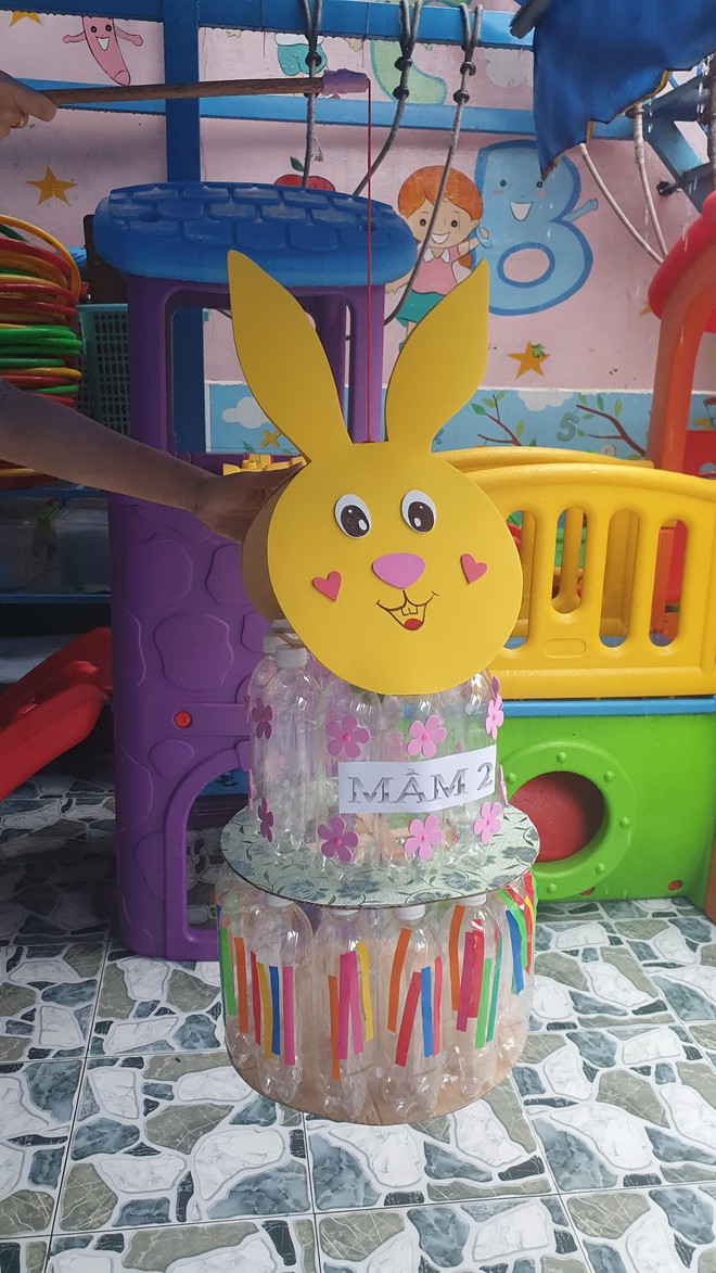 Những miếng giấy màu cắt thành đường thẳng được các em dán vào chai làm thành chiếc đầm cho chị thỏ ngọc ẢNH: TẤN ĐẠT