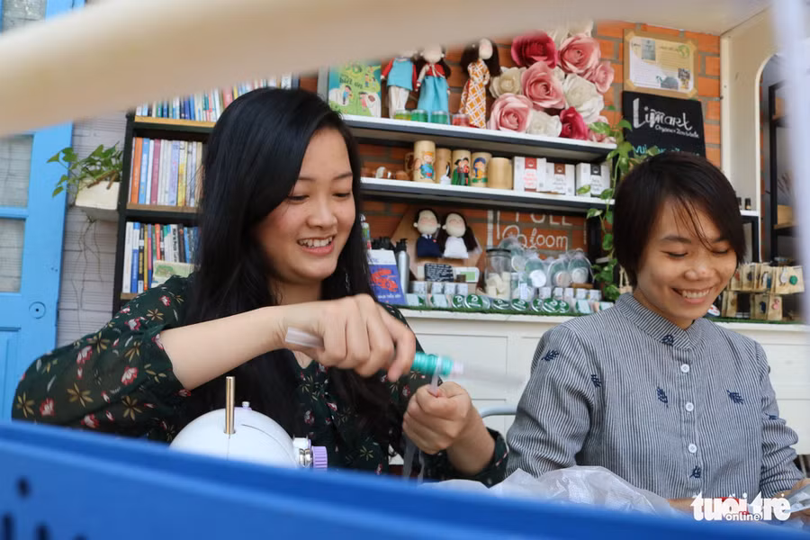 Kim Hằng (trái) cùng bạn đang cuộn lại những cuộn nilông sau khi đã cắt mỏng thành sợi để không bị rối - Ảnh: HOÀNG AN