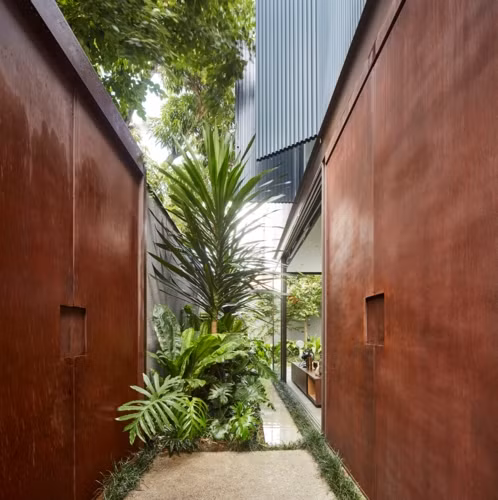 Tương phản với tường thép cứng nhắc chính là vườn cây xanh mát.