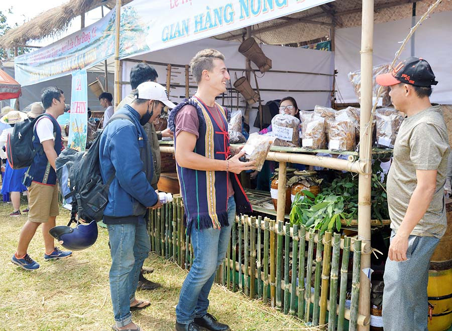  Du khách nước ngoài mua sản phẩm nông sản sạch. Ảnh: Hà Tây