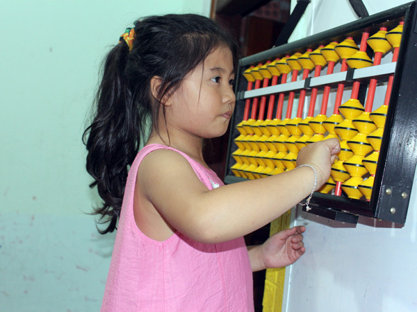 Trẻ luyện tập tính toán bằng bàn tính cổ soroban tại Smart Kids Gia Lai. Ảnh: N.G