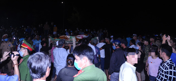 Lực lượng chức năng đưa thi thể nạn nhân chết đuối vào bờ - Ảnh: LÊ TRUNG