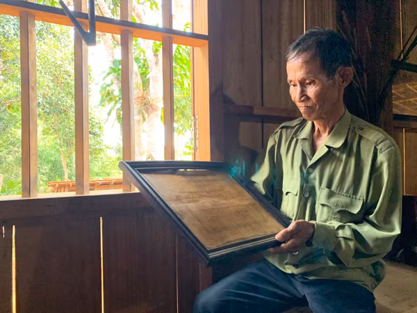  Ông Đinh Văn Đoàn (làng Hà Nừng, xã Sơn Lang, huyện Kbang) bên tấm bằng khen vì có thành tích đóng góp xây Lăng Bác. Ảnh: P.L