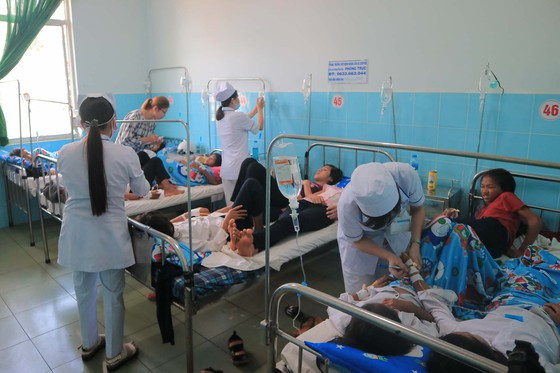 Các bác sĩ, điều dưỡng thăm khám cho những học sinh nghi ngộ độc thực phẩm. Ảnh: ĐOÀN KIÊN