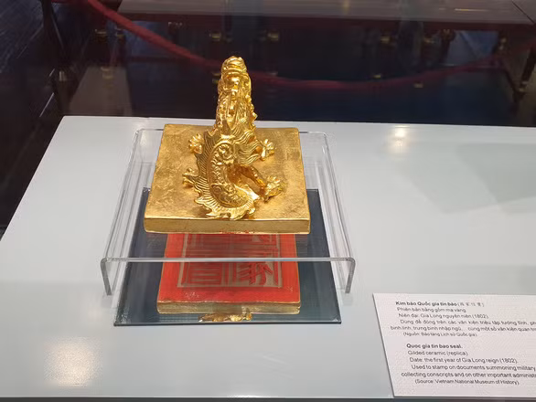 Kim bào Quốc gia tín báo thời Triều Nguyễn được phát họa lại phiên bản bằng gốm mạ vàng được trưng bày - Ảnh: PHƯỚC TUẦN