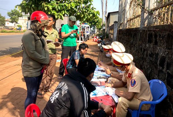 Cảnh sát Giao thông Công an tỉnh lập biên bản các trường hợp vi phạm tại chốt kiểm soát phương tiện giao thông cơ giới đường bộ đặt trên quốc lộ 19. Ảnh: L.H
