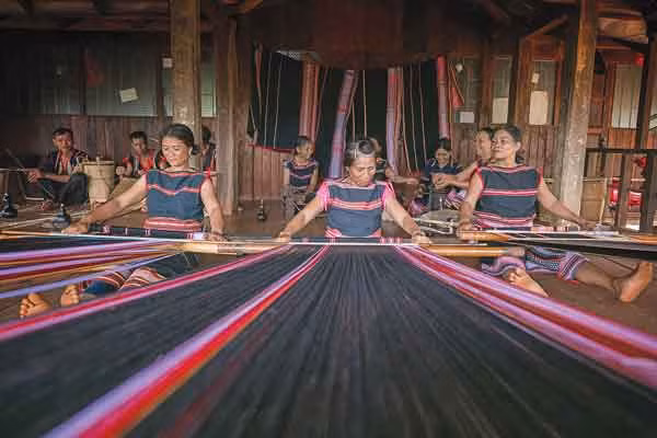 Thành viên Câu lạc bộ Dệt thổ cẩm xã Ia Mơ Nông trình diễn dệt thổ cẩm phục vụ du khách. Ảnh: Nguyễn Linh Vinh Quốc