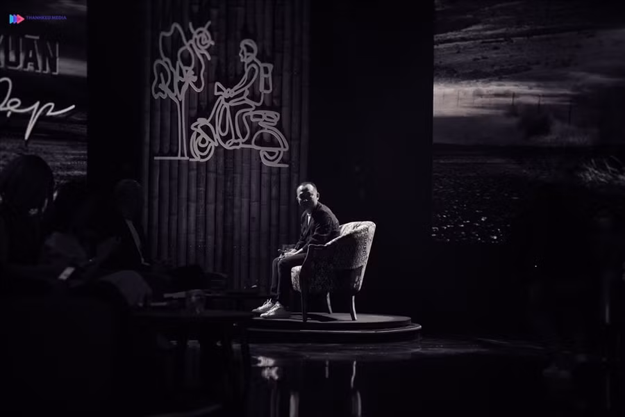 Nhạc sĩ Quốc Trung ngồi trên ghế hồi đáp của chương trình 