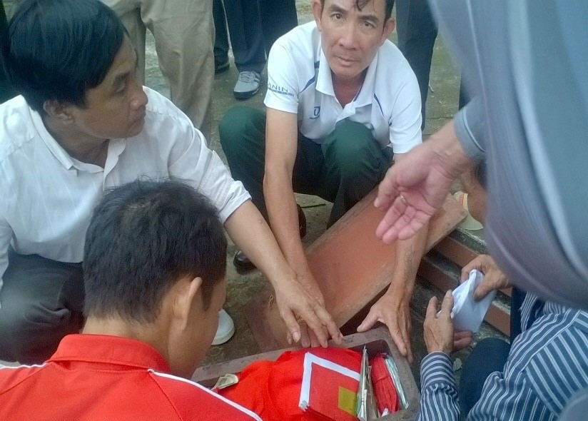 Ông Phan Tư Lam bốc hài cốt đồng đội Hoàng Khắc Hoàn, đưa anh về quê mẹ ở tỉnh Thanh Hóa. Ảnh: NVCC