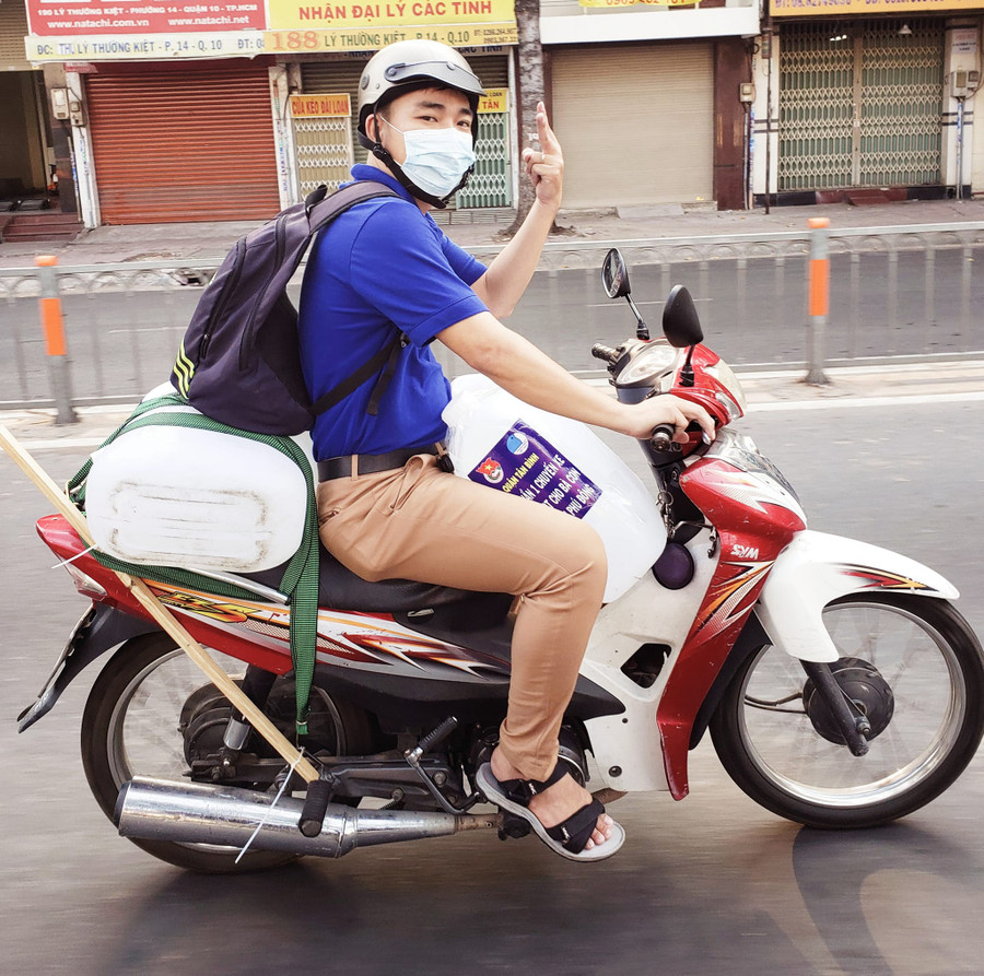 Anh Phong trong lần chở nước về miền Tây bằng xe máy để cứu giúp người dân qua cơn hạn mặn năm 2020. Ảnh: NVCC