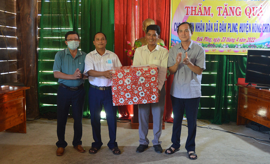  Trưởng ban Dân vận Tỉnh ủy Võ Thanh Hùng (bìa phải) tặng quà cho Đảng ủy-HĐND-UBND-Ủy ban MTTQ Việt Nam xã Đak Pling. Ảnh: An Nguyên