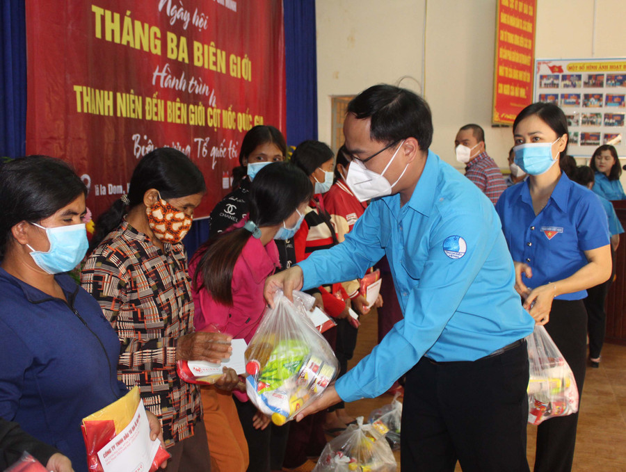 Anh Đỗ Đức Thanh-Phó Bí thư Tỉnh Đoàn, Phó Chủ tịch Hội LHTN Việt Nam tỉnh tặng quà cho người dân xã Ia Dom (huyện Đức Cơ) trong ngày hội “Tháng ba biên giới”. Ảnh: Phan Lài