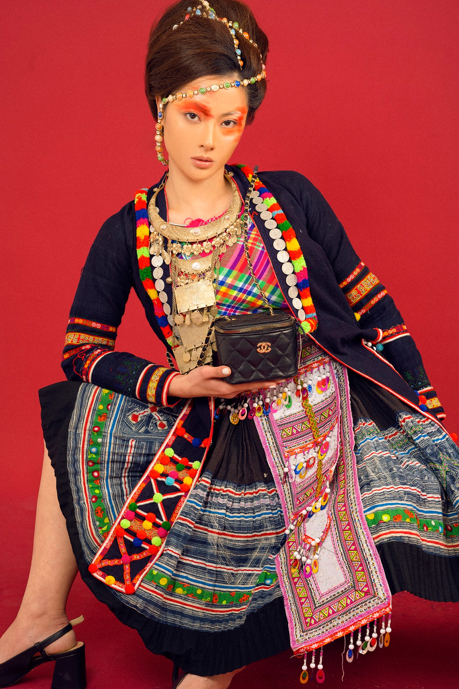  Ma mị và đầy táo bạo, cô và ê kíp cũng đã mạnh dạn lựa chọn đôi sling black gót vuông cùng túi chanel trong bộ trang phục mang đậm nét truyền thống của người Dao.