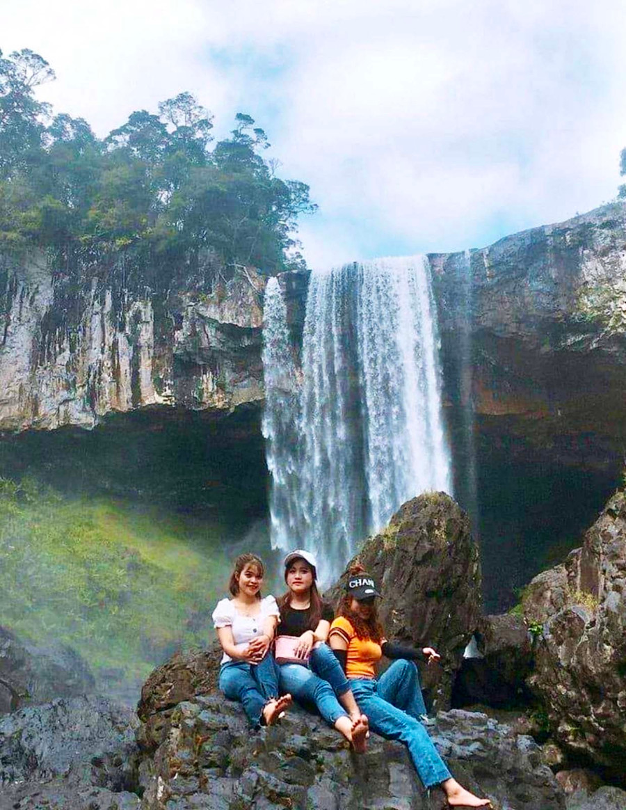 Du khách chụp ảnh lưu niệm bên thác 50 (Khu Dự trữ sinh quyển thế giới Cao nguyên Kon Hà Nừng). Ảnh: Lam Nguyên