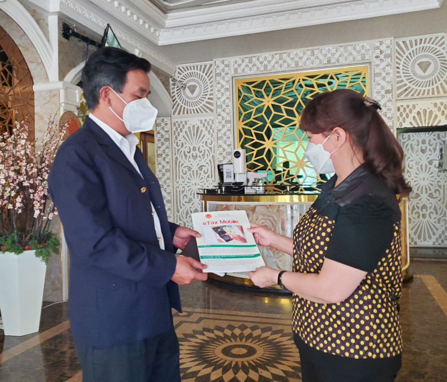 Cán bộ Chi cục Thuế TP. Pleiku hướng dẫn người nộp thuế đăng ký sử dụng hóa đơn điện tử. Ảnh: Sơn Ca