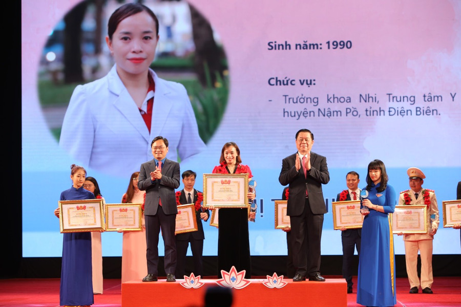 Ông Nguyễn Trọng Nghĩa và anh Nguyễn Anh Tuấn trao danh hiệu cho các y bác sĩ được tuyên dương. Ảnh: Bảo Anh