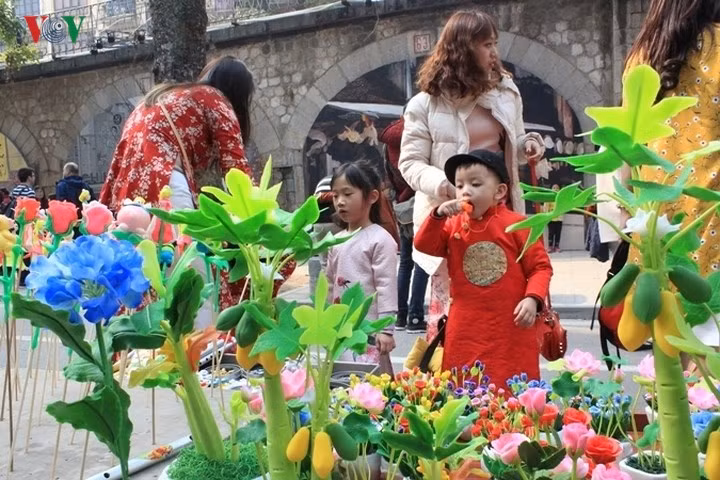 Nhiều bố mẹ dẫn theo con cái ra chợ du xuân và tìm những món quà cần thiết cho ngày Tết.