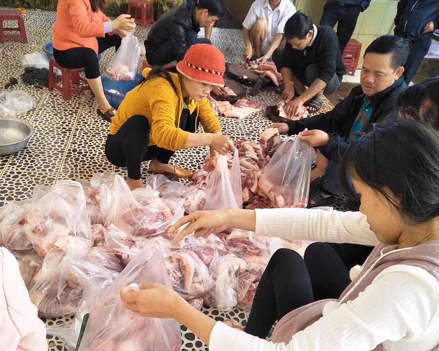  Thầy, cô giáo chia thịt heo cho các học sinh. Ảnh: N.T