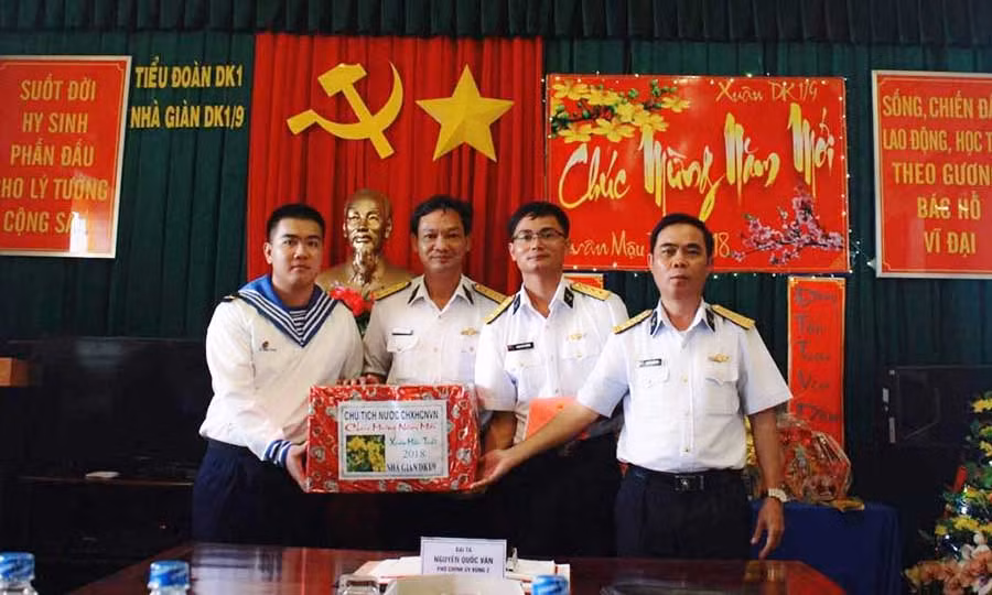 Phó Chính ủy Vùng 2 Hải quân Nguyễn Quốc Văn (bìa phải) trao quà tết cho nhà giàn DK1/9. Ảnh: Việt Hưng 