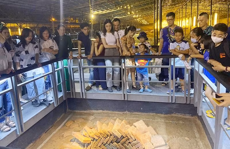 Khách du lịch tham quan giếng cổ trong Hoàng thành Thăng Long (Hà Nội). Ảnh: Chí Dũng