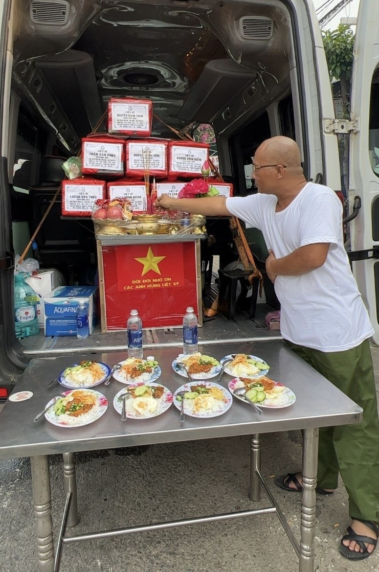 Anh Hùng cúng cơm cho các liệt sĩ vừa được bốc hài cốt. Ảnh: NVCC