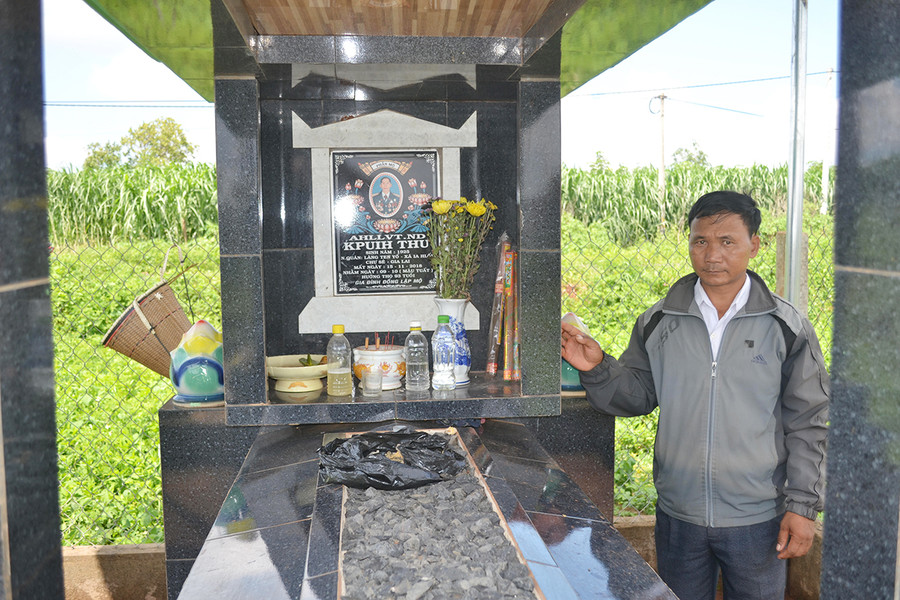  Ông Kpuih Lan-Chủ tịch Hội Nông dân xã Ia Hlốp (huyện Chư Sê) bên mộ Anh hùng Kpuih Thu. Ảnh: Hoàng Minh