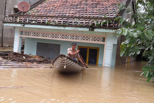 Tỉnh Phú yên chịu thiệt hại nặng nề do mưa lũ khi ít nhất đã có 7 người chết và 1 người mất tích - Trong ảnh: một người dân ở xã An Định, huyện Tuy An, tỉnh Phú Yên vội vã chạy lũ