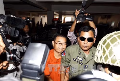 Cảnh sát áp giải ông Hong Sok Hour (giữa) tới tòa án Phnom Penh ngày 2-10.