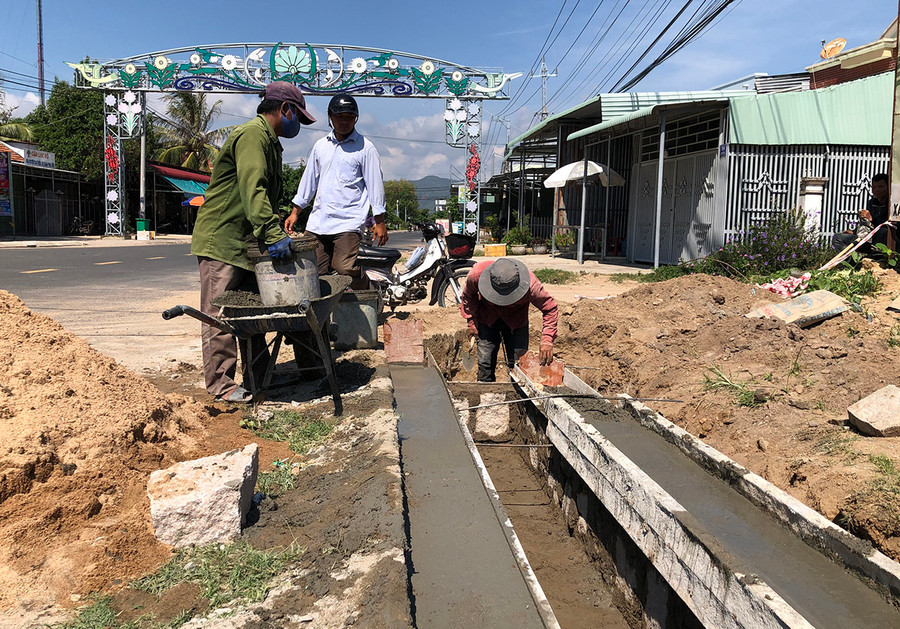  Công nhân Công ty TNHH Xây dựng Phát Trọng Tín lát vỉa hè đường Thống Nhất (thị trấn Phú Túc). Ảnh: G.H