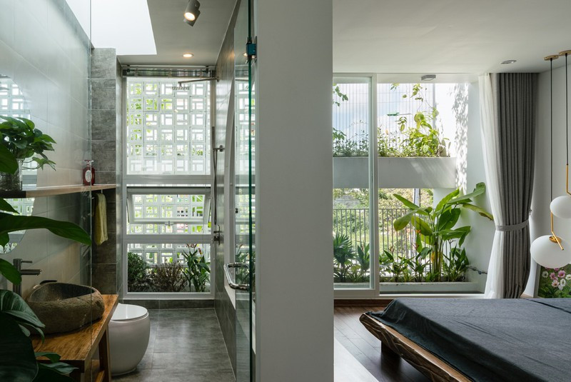  Phòng tắm hẹp nhưng sáng nhờ mặt cắt cong, cửa sổ cao và giếng trời.