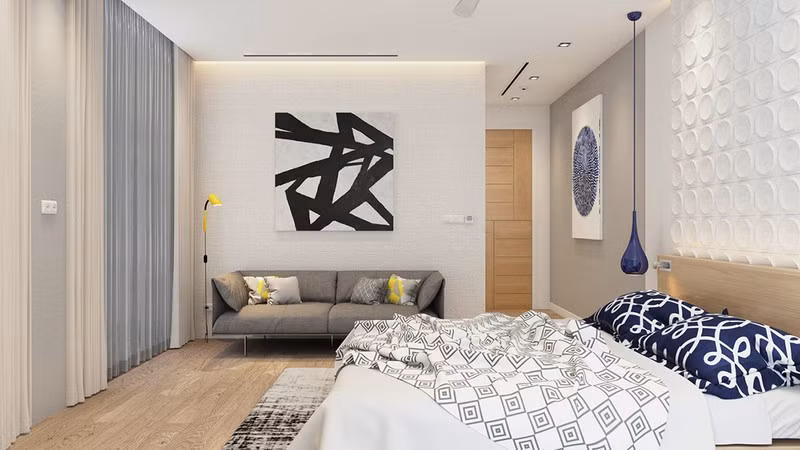 Một chiếc đèn màu vàng đặt cạnh ghế sofa để tạo điểm nhấn.