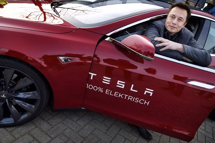 Elon Musk với chiếc xe điện của Tesla. Ảnh: AFP