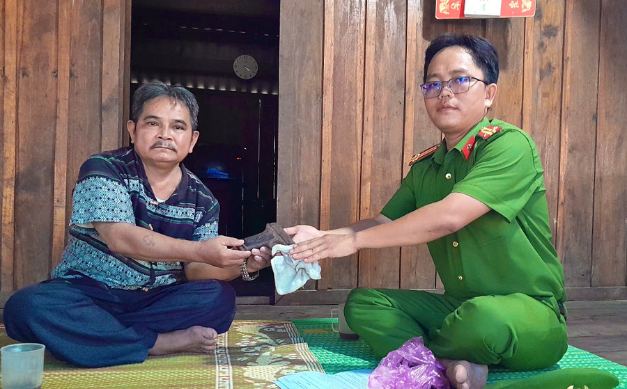 Ông Đinh Văn Rốp giao nộp khẩu súng cho Công an xã. Ảnh: ĐVCC 2-5231.jpg