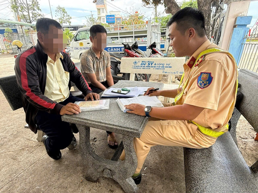 Cán bộ Đội Cảnh sát giao thông đường bộ số 4 làm việc với tài xế N.Đ.L. (bìa trái) và phụ xe của nhà xe T.Q.D. Ảnh: ĐVCC 13.jpg