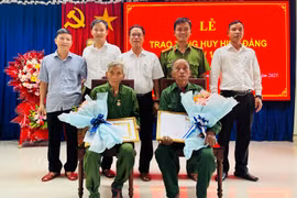 Lãnh đạo xã Canh Liên trao Huy hiệu 45 tuổi Đảng tặng các đảng viên. Ảnh: T.C