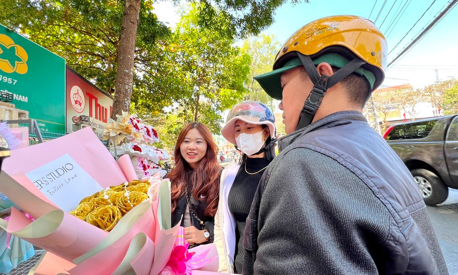 Em Đỗ Thị Vy (thứ nhất bìa trái), tổ 3, phường Hoa Lư, TP. Pleiku, hiện là sinh viên năm nhất Trường Đại học Tài chính-Maketing TP. Hồ Chí Minh tất bật tham gia kết hoa cùng chị gái để bán trong dịp Tết và Ngày Valentine (14-2). Ảnh: Đinh Yến