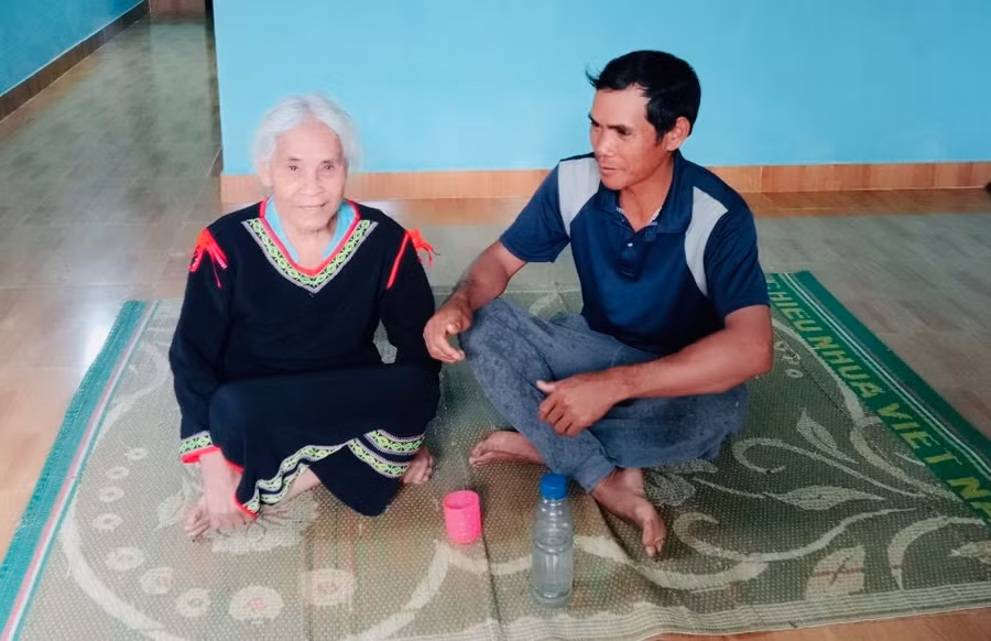 Bà H’Yat (làng Yăng 3, xã Ia Phí, huyện Chư Păh) trò chuyện với trưởng thôn AYung. Ảnh: Đinh Yến