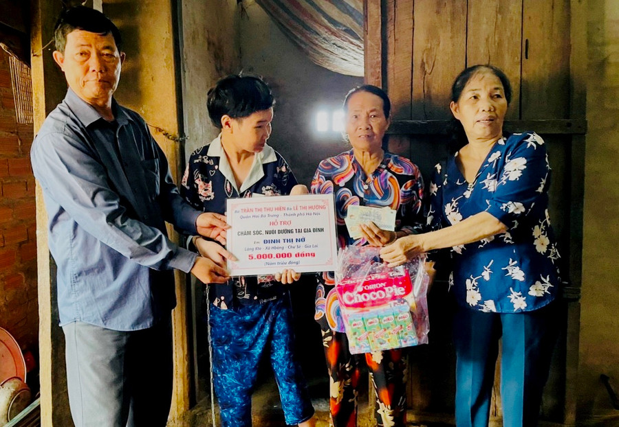 Bà Lê Thị Hường trao số tiền chăm sóc, nuôi dưỡng cho cháu Đinh Thị Nở. Ảnh: Đ.Y