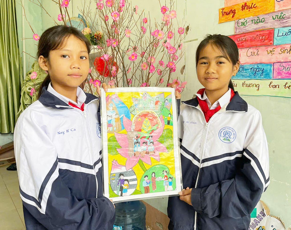 Em Nay H’Đin (bìa phải) và Nay H’Cá (lớp 6, Trường THCS Dân tộc Nội trú thị xã Ayun Pa) đã cùng nhau hoàn thành bức tranh ý nghĩa để tham gia cuộc thi vẽ tranh do Hội đồng Đội thị xã tổ chức. Ảnh: Vũ Chi 2vc.jpg