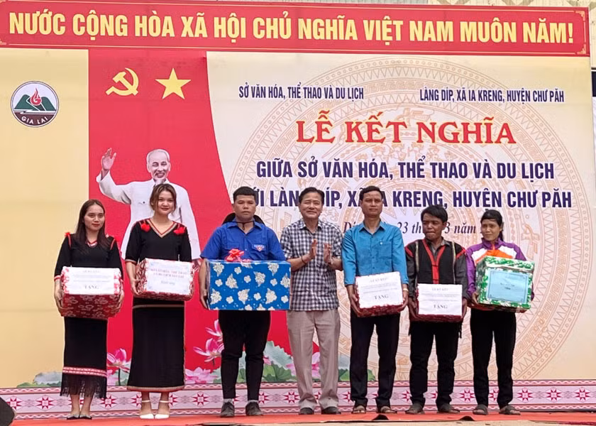 Tặng quà đại diện cấp ủy, đoàn thể và người dân làng Díp. Ảnh: Minh Châu