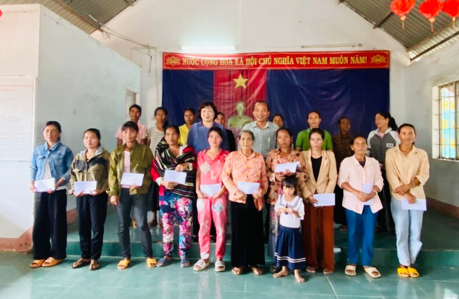 Trưởng ban Dân vận Tỉnh ủy Phạm Thị Tố Hải và Phó Bí thư Thường trực huyện ủy Krông Pa Kpă Ngun tặng quà các hộ nghèo của buôn. Ảnh: Thanh Tâm